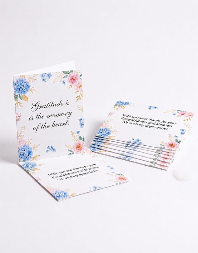 Folded floral invitation and thank-you cards with elegant design.
